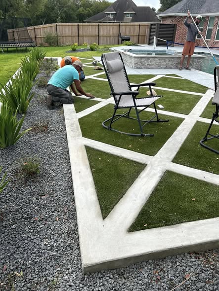 Geometric concrete flatwork with grass insets around a backyard pool area
